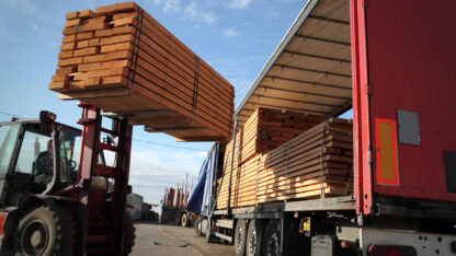 Forklift loading truck with construction materials